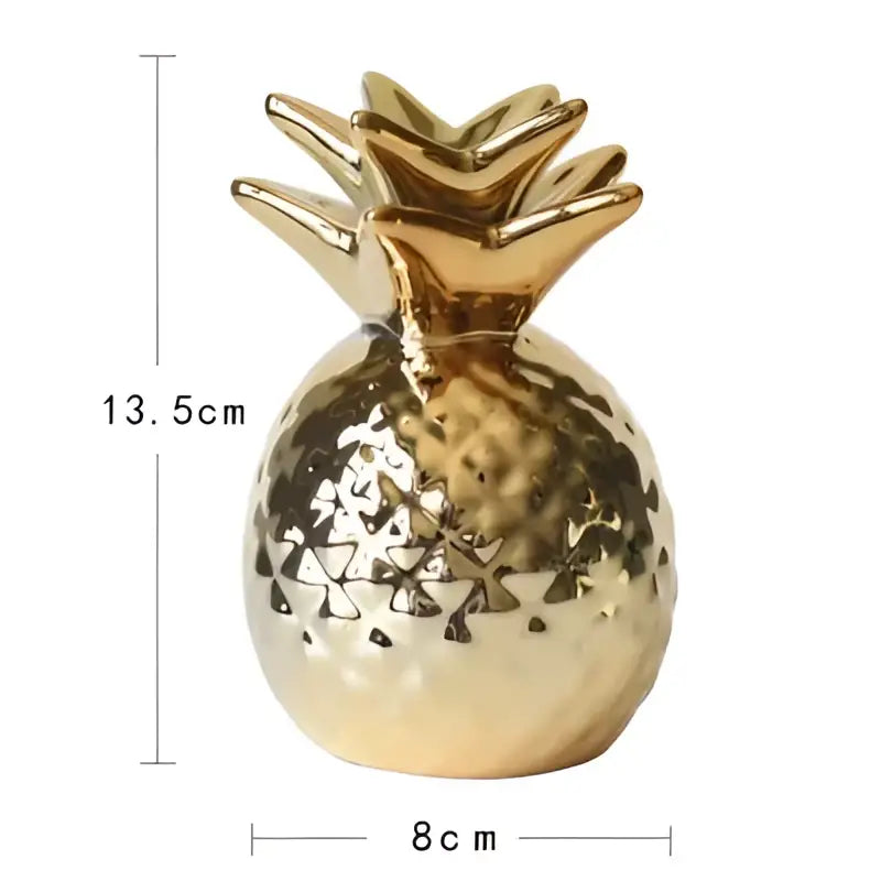 Abstract golden eagle resin statue resembling a gold resin pineapple with textured hammered finish and leafy top for decor