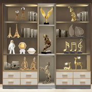 Abstract golden eagle gold resin statue with outstretched wings on a black base for living room decor