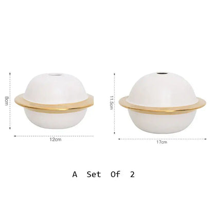 White ceramic diffuser with gold metallic ring base shown alongside abstract gold resin statue for living room decor