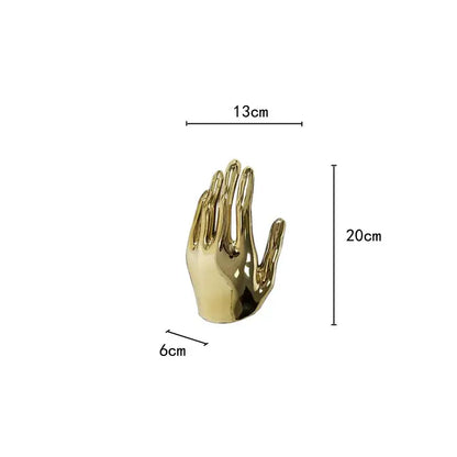 A polished gold-colored metallic hand-shaped decorbites abstract golden hands resin sculpture for living room decor