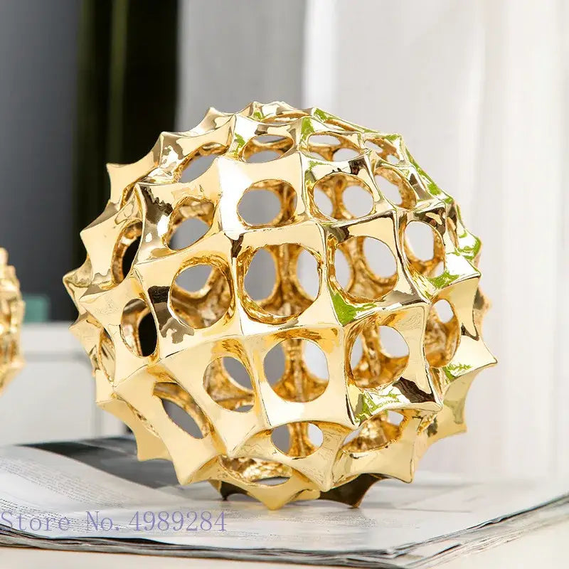 Abstract golden metal hollow ball spike ornament with geometric pattern and metallic finish for living room decor
