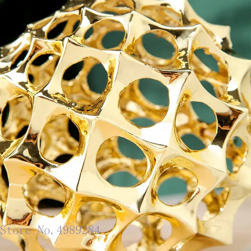 Abstract golden metal hollow ball spike ornament with faceted honeycomb design for living room decor