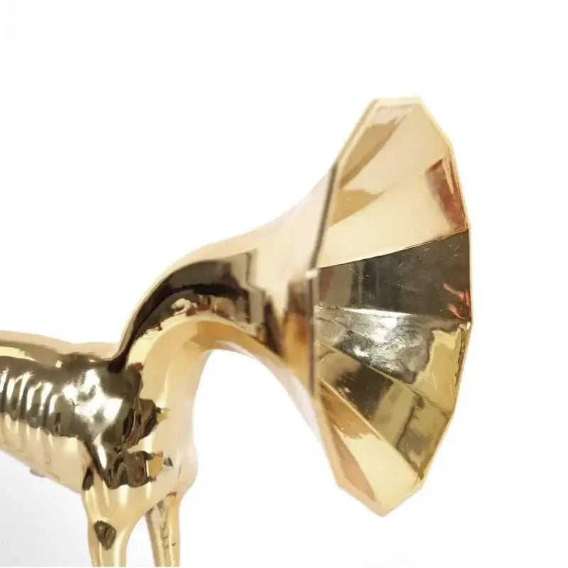 Abstract golden trumpet dog sculpture featuring a polished metallic finish and intricate faceted design for living room decor