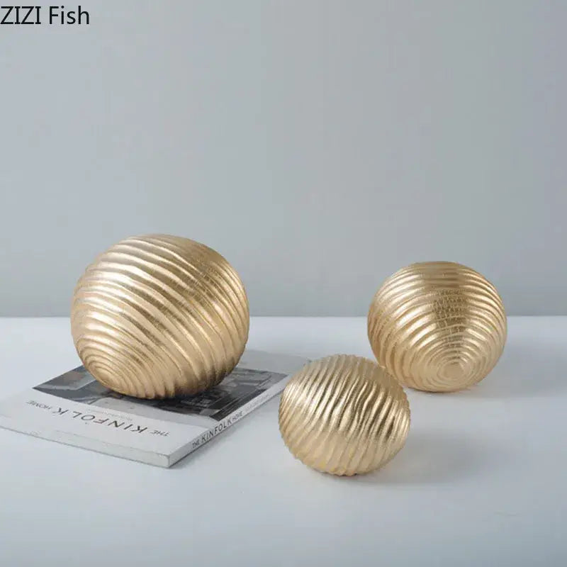 Gold-colored ribbed metal decorative spheres with a metallic finish abstract golden wave ball sculpture for living room decor