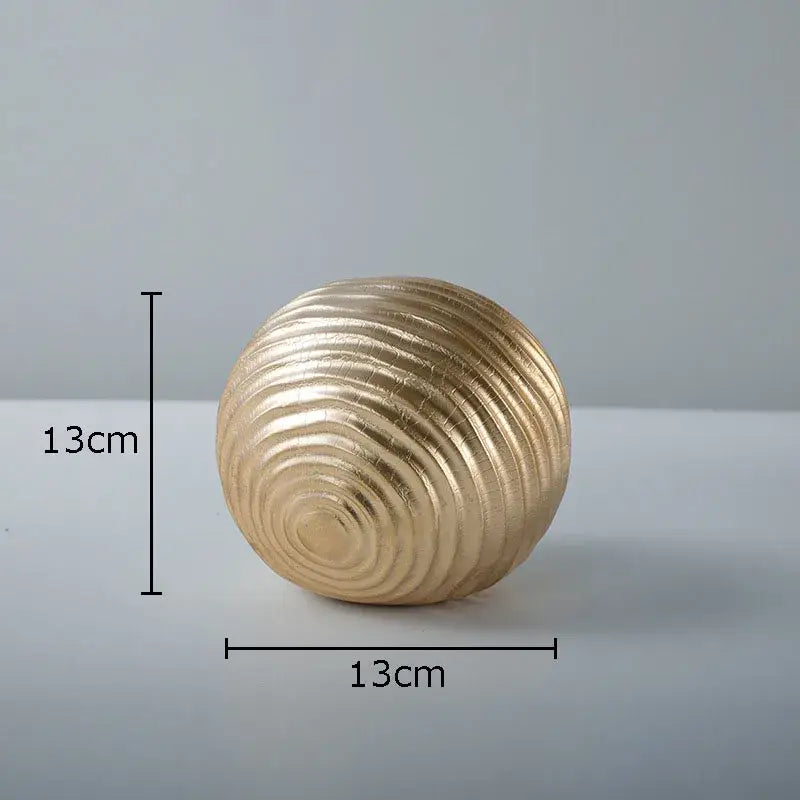 A 13cm diameter golden wave ball sculpture with concentric textured ridges for living room metal decor