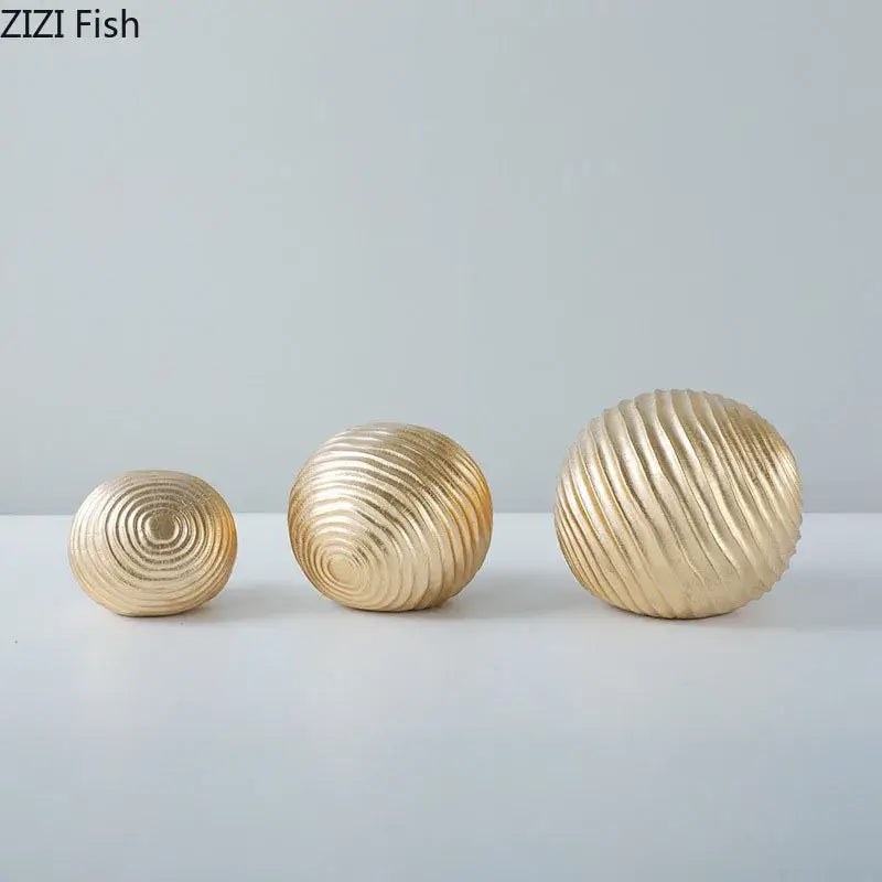 Set of three gold-toned decorative golden wave balls with concentric ridged patterns for living room decor