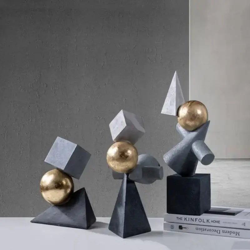Modern abstract gray and gold ball sculpture with geometric gold features for living room decor by decorbites