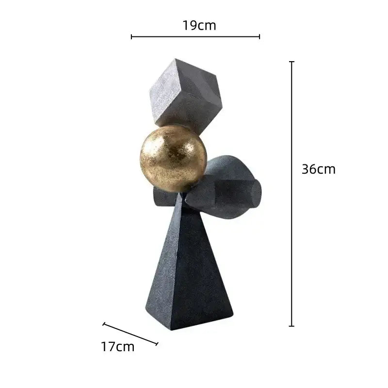 A modern abstract decorbites geometric gold ball sculpture with a black base, gray cube, and metallic gold sphere for living room decor