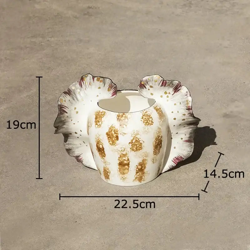 White ceramic butterfly wings vase with gold leaf patterns and fluted petal-like sides for bedroom decor