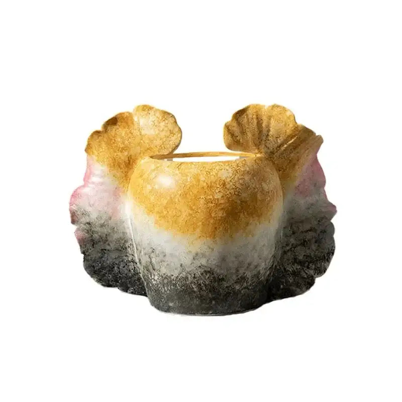 A ceramic butterfly wings vase with gradient gold pink and black scalloped edges for bedroom decor