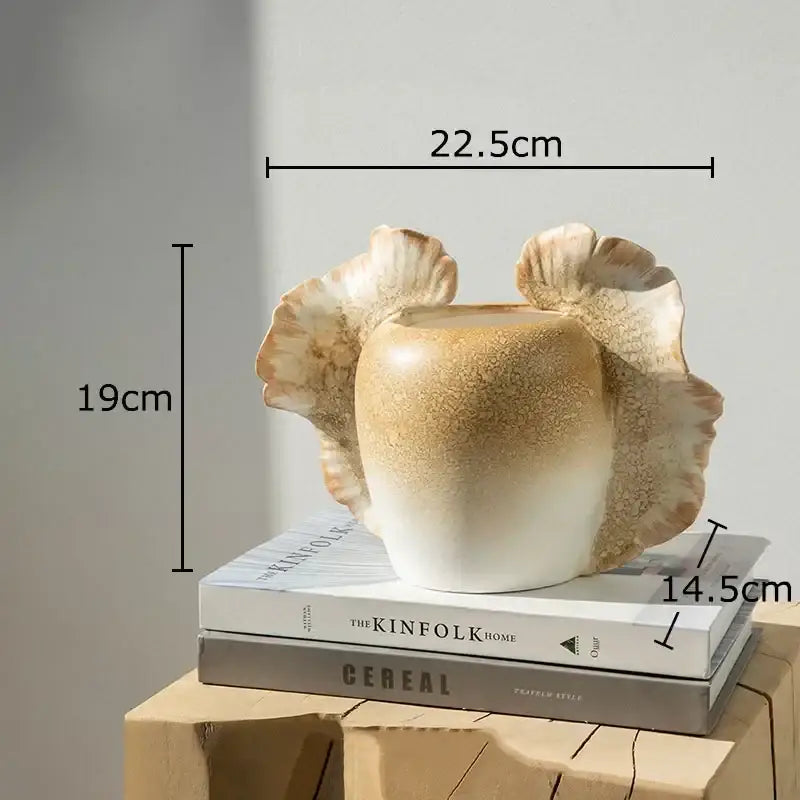 Creamy beige ceramic butterfly wings vase with fluted leaf handles and textured glaze for bedroom decor