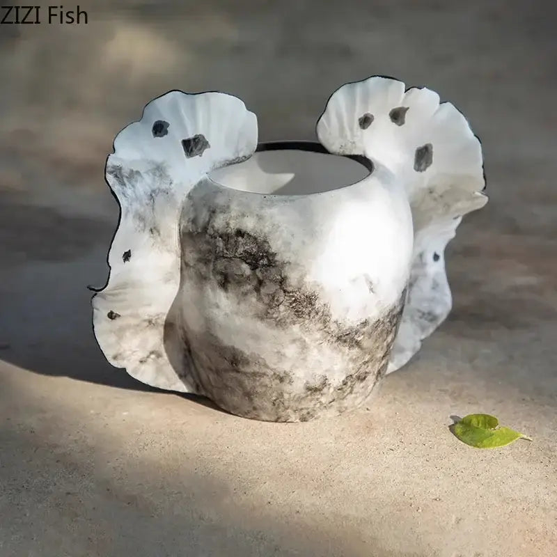 A white ceramic butterfly wings vase with marbled gray pattern and leaf-shaped handles for bedroom decor
