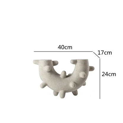 Gray concrete u-shaped candle holder with textured surface and rounded protrusions geometric cactus resin decor