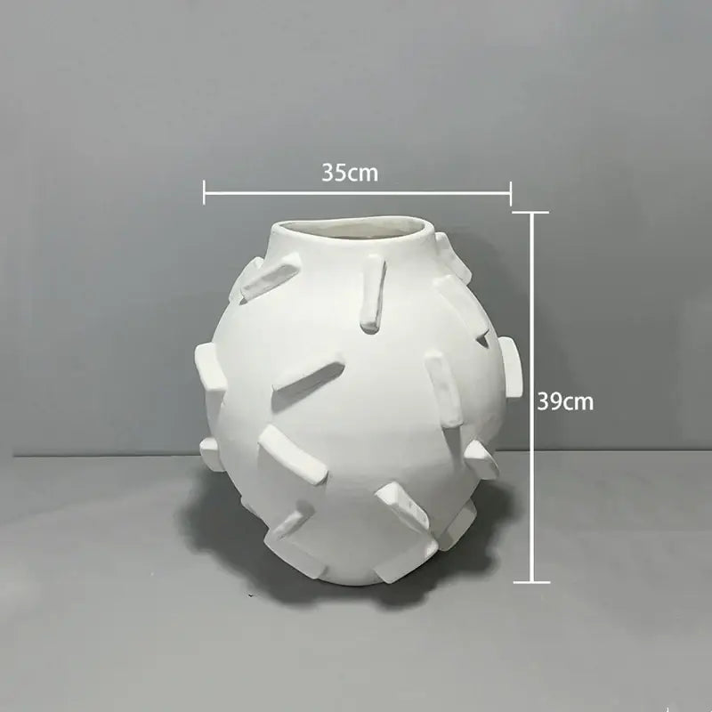 White ceramic geometric block vase with rounded body and rectangular tabs for decorbites geometric block living room decor