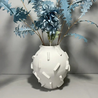 White ceramic geometric block vase with rounded body and rectangular ridges for decorbites geometric block living room decor