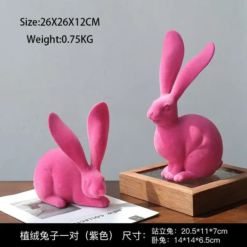 Pair of vibrant pink plush rabbit figurines with one standing and one sitting complement abstract rabbit figurines decor