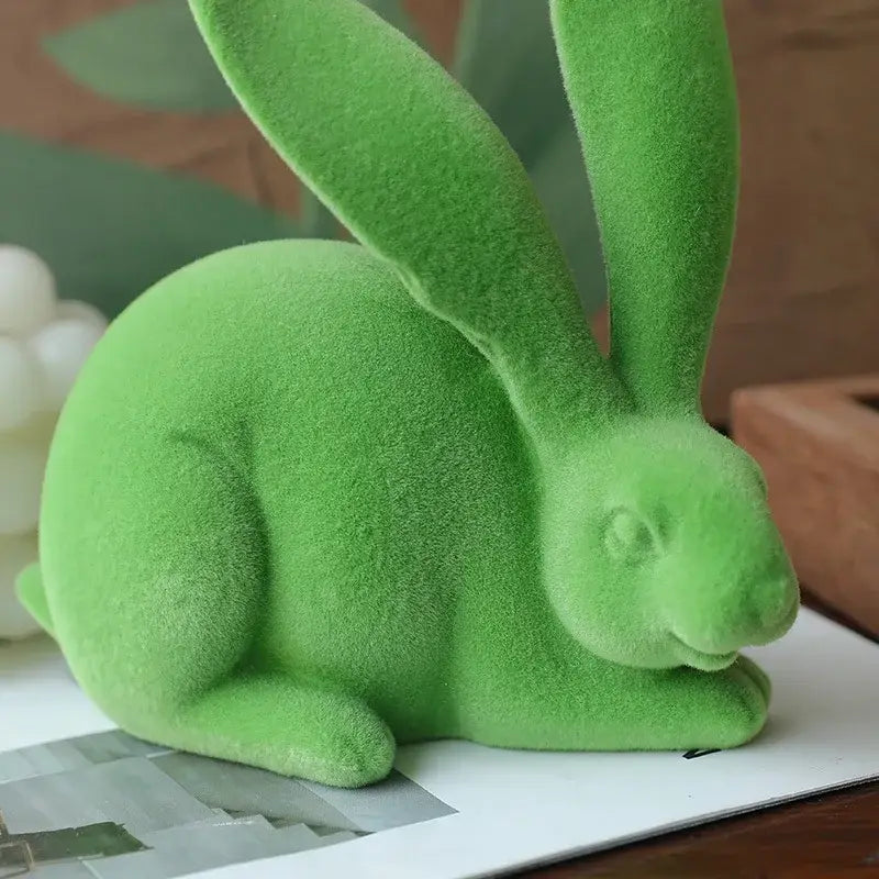 A plush vibrant green abstract rabbit figurine with long ears and velvety texture for living room decor