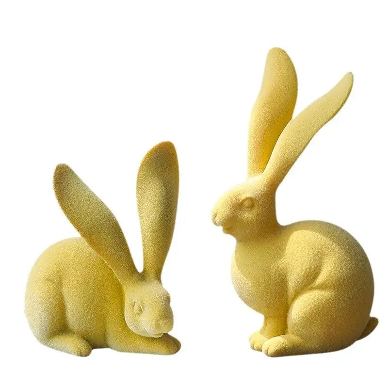 Two matte yellow resin rabbit figurines featuring abstract rabbit design for living room decor art display