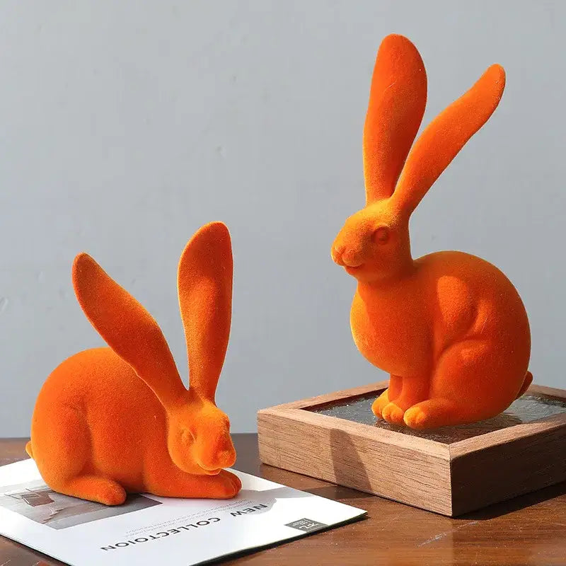 Orange velvet abstract rabbit figurines made of resin for living room decor art with green and blue accents