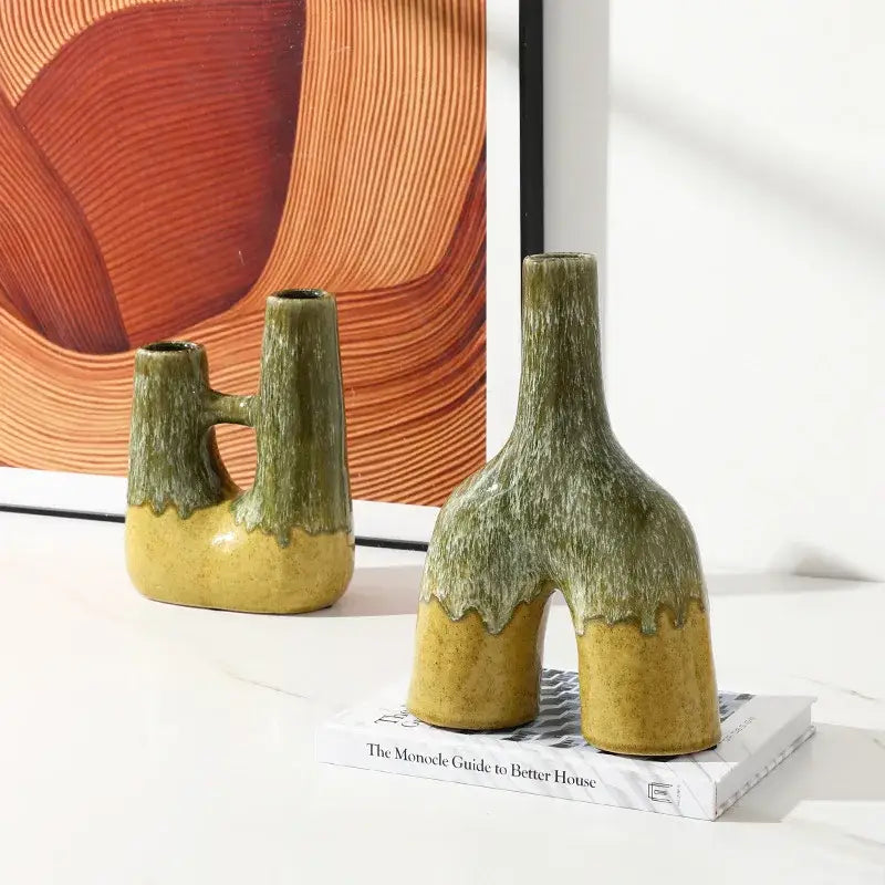 Two glaze ceramic vases with abstract green and yellow kiln-changing glaze and asymmetrical split-leg design for decorbites abstract living room decor