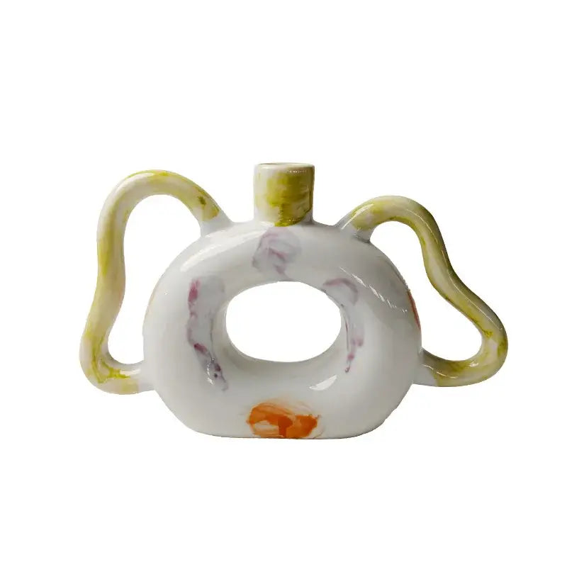 White ceramic abstract handle vase with yellow purple orange glaze accents for green and red living room decorbites decor