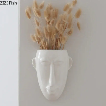 White ceramic abstract human face ceramic vase wall decor holding dried beige pampas grass for living room