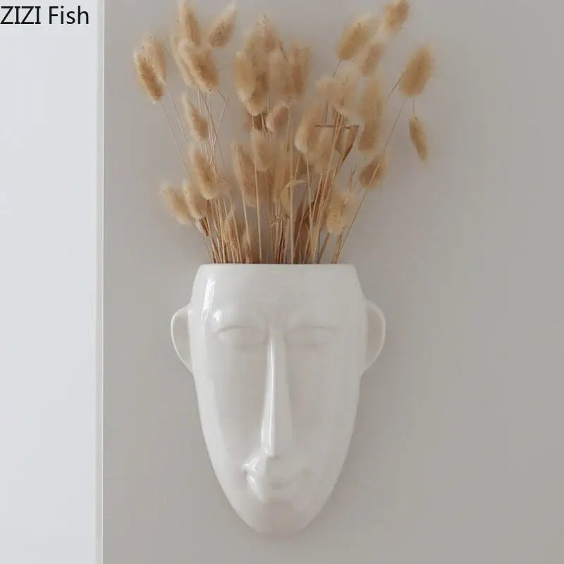White ceramic abstract human face ceramic vase wall decor holding dried beige pampas grass for living room