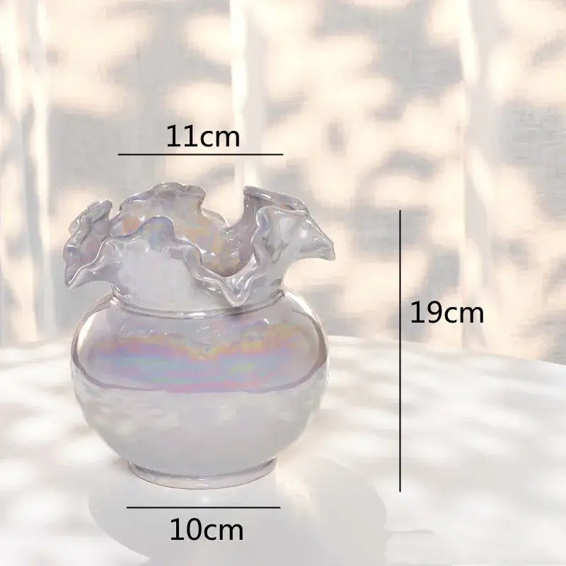 A translucent iridescent glass vase with a rounded body and ruffled rim for decorbites ceramic shell living room decor