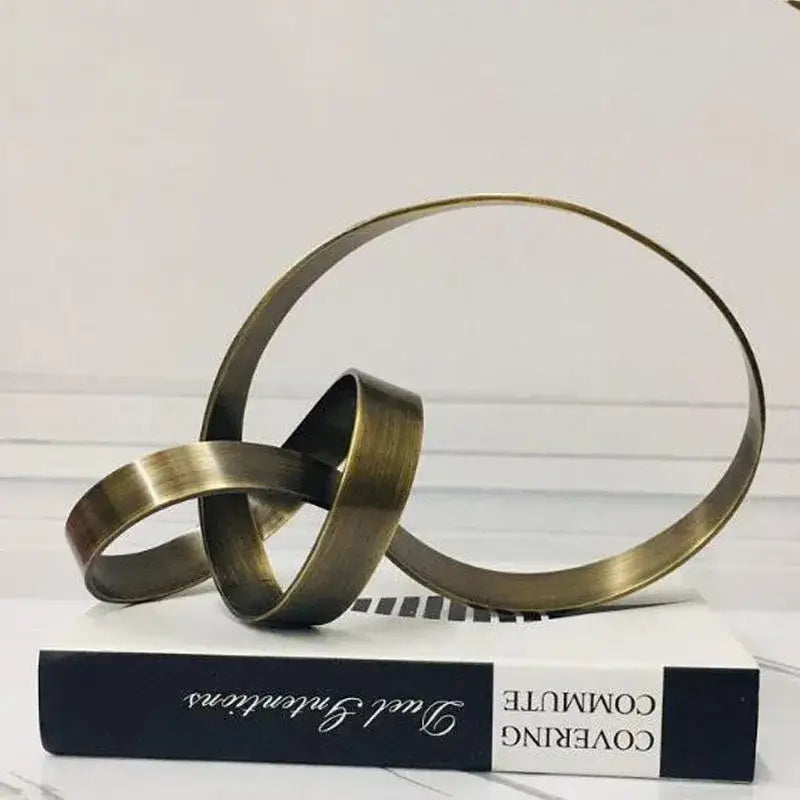 Antique brass colored abstract knot golden metal sculpture with interlocking rings for living room decorbites decor