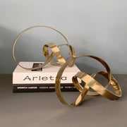 Abstract knot golden metal sculpture with interlocking circular bands for living room decorbites abstract knot decor