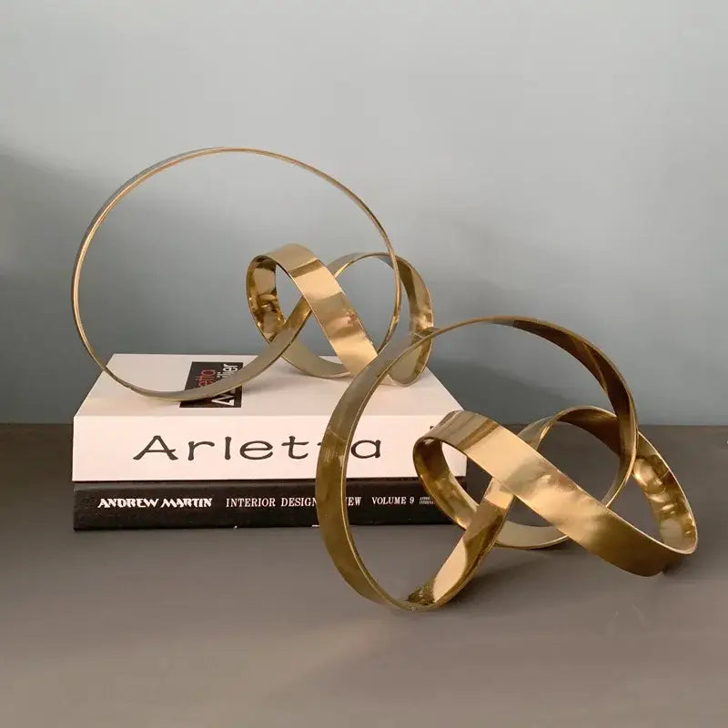 Abstract knot golden metal sculpture with interlocking circular bands for living room decorbites abstract knot decor