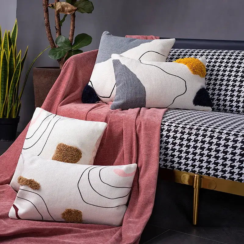 White rectangular cushion cover with abstract line colors design and textured brown pom-pom accents for living room decorbites abstract line