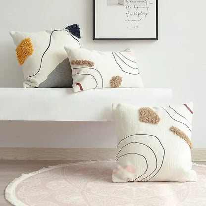 White textured cushion cover with abstract line colors and beige yellow pink felt accents for living room decorbites
