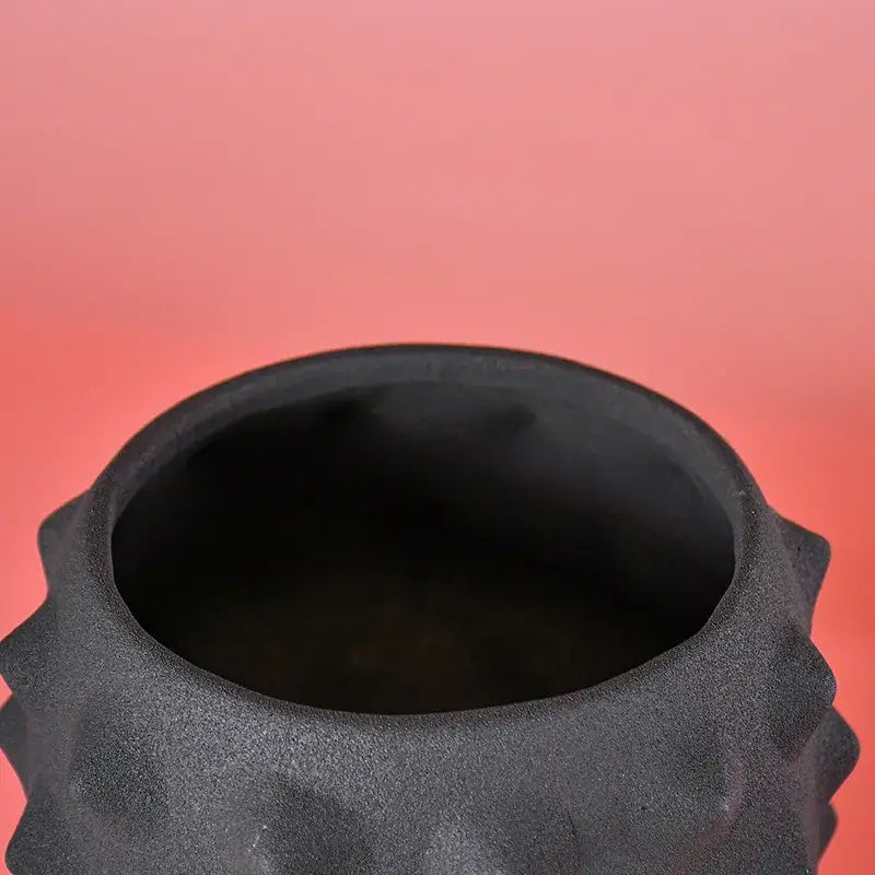Abstract matte black ceramic sea urchin vase with ridged textured surface for living room decor by decorbites black ceramic