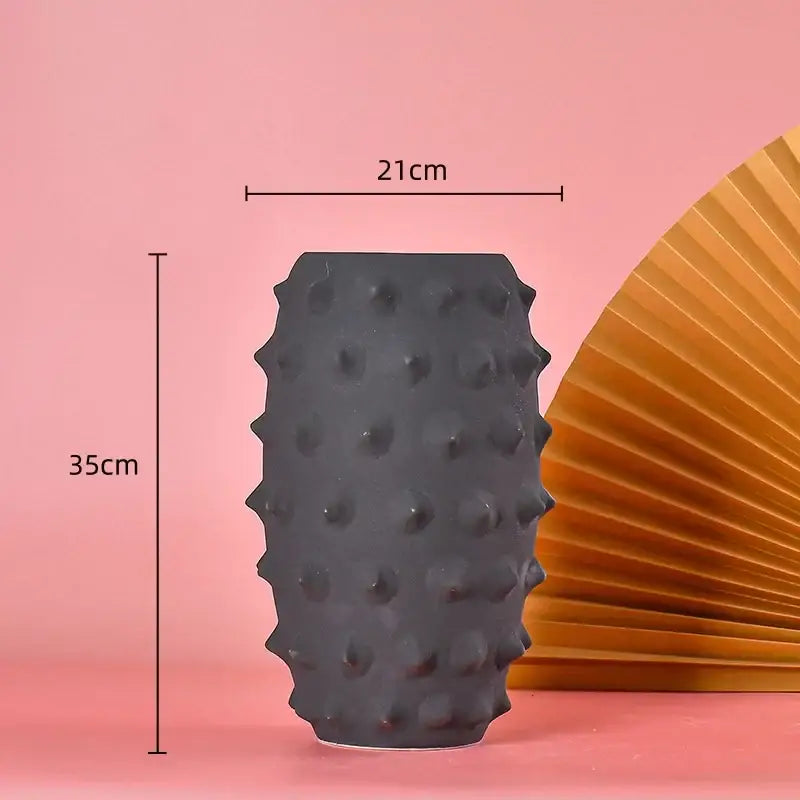 A matte black ceramic sea urchin vase with textured raised bumps for living room decorbites black ceramic decor