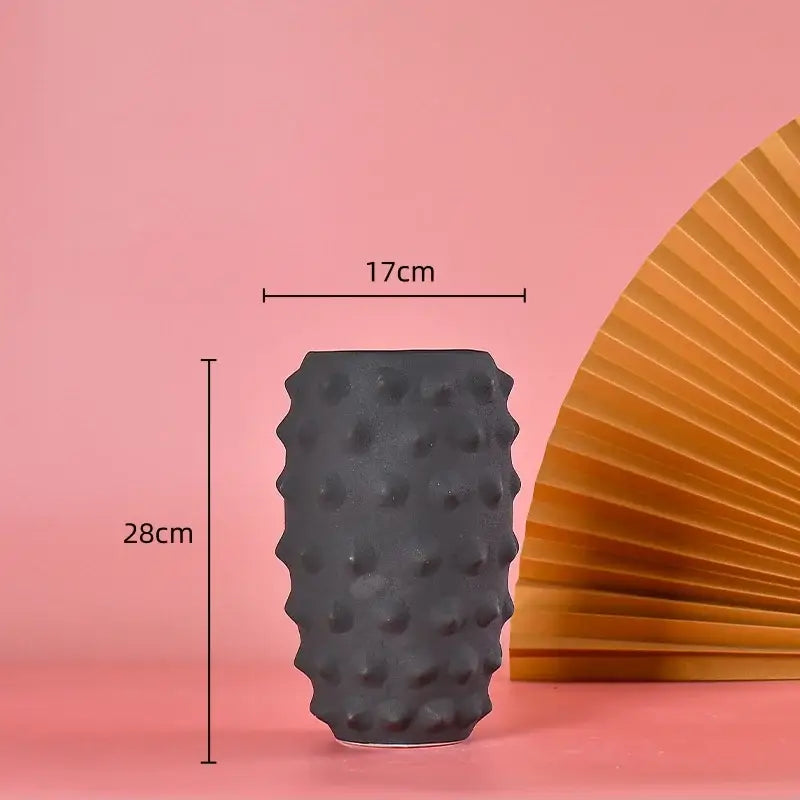 A matte black ceramic sea urchin vase with textured bumps, 28cm tall and 17cm wide for living room decor
