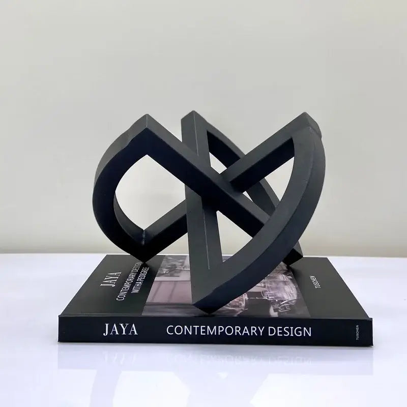Black ornament abstract geometric sculpture with matte finish and interlocking loops for abstract home decoration