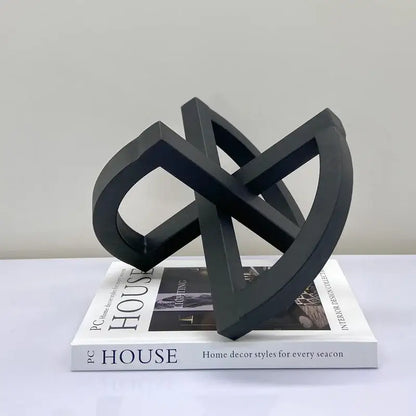 Black matte-finished abstract geometric sculpture with interlocking loops for abstract home decoration living room