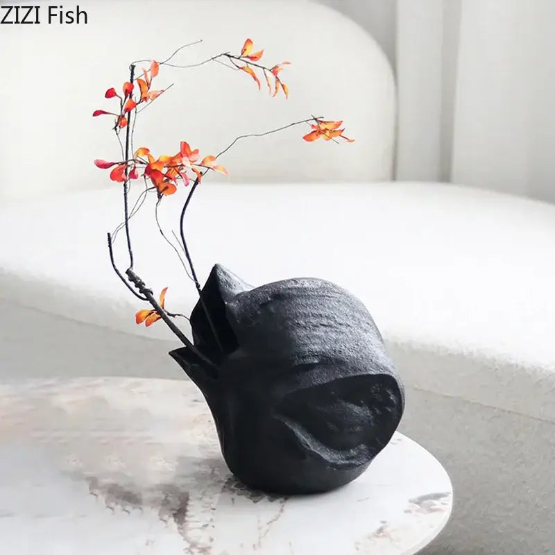 Abstract artwork decorbites black vase black textured ceramic vase with organic form holding orange red artificial branches