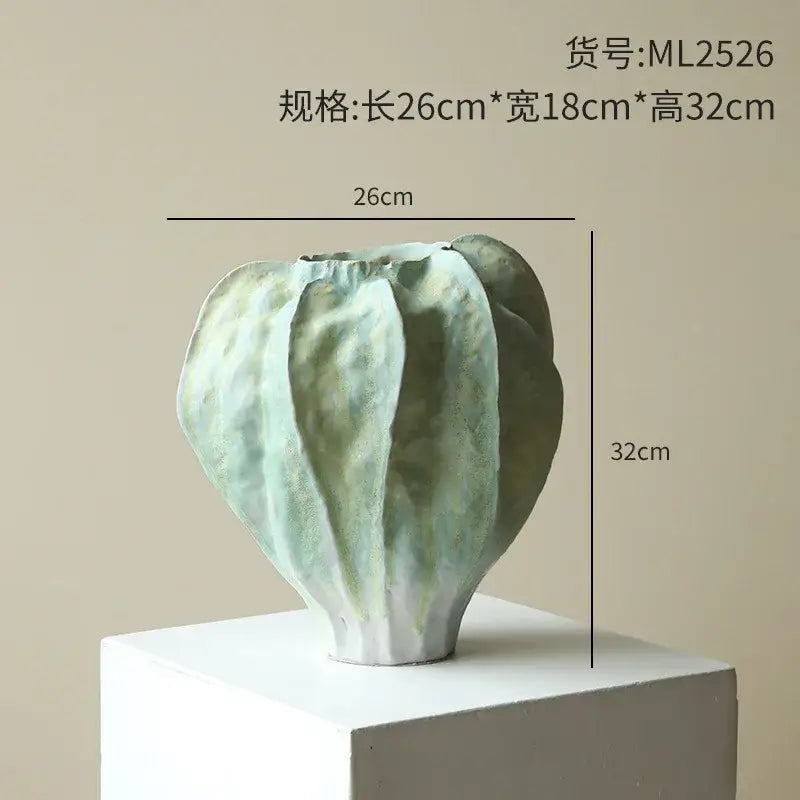 Abstract irregular folds ceramic vase in muted mint and olive green with textured segmented surface for living room decor