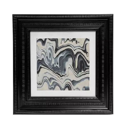 Black beaded picture frame holding abstract modern wall art with flowing gray white and black swirls for decorbites decor