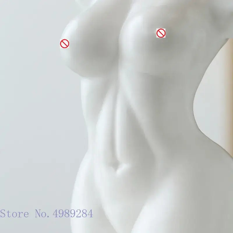 Abstract nude female white ceramic torso vase with smooth glossy finish and sculpted contours for living room decor
