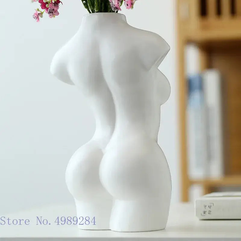 White ceramic vase shaped like an abstract nude female torso with smooth sculpted curves for living room decor