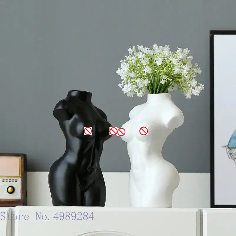 Abstract nude female black and white ceramic torso vases with one holding white flowers for living room decor