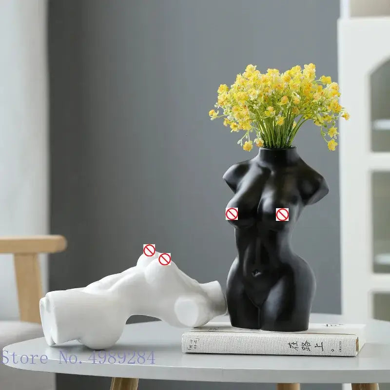 Black ceramic abstract nude female torso vase with yellow flowers for elegant living room decor