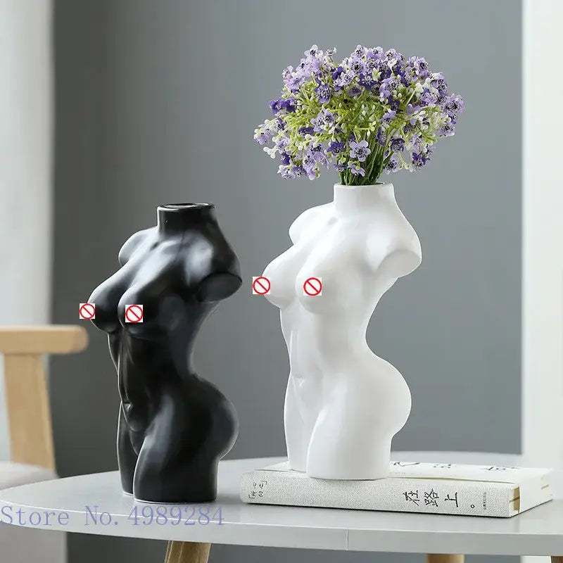 White ceramic abstract nude female torso vase holding purple and green flowers for living room decor