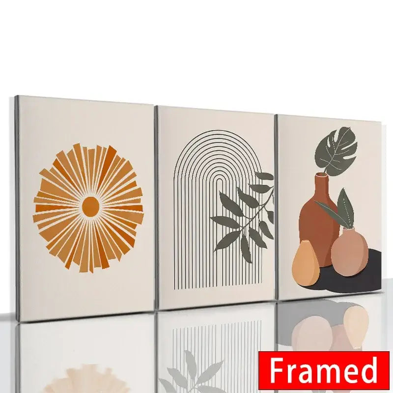 Set of three framed canvas leaf posters with abstract orange minimalist botanical and geometric designs in earthy tones