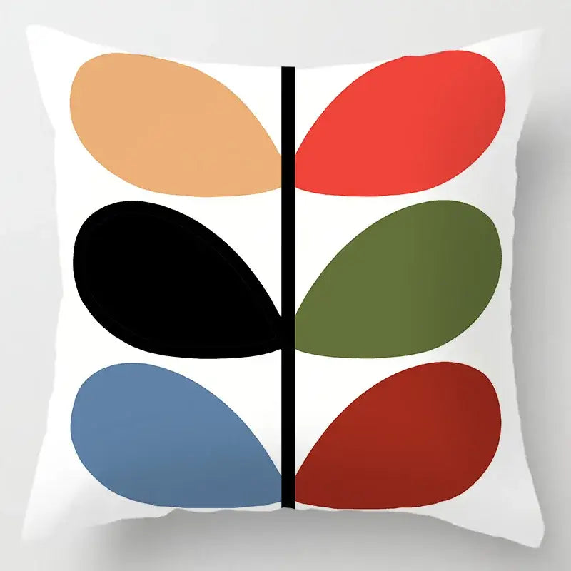 White cushion cover with bold geometric leaves print featuring six colorful oval petals and a central black line