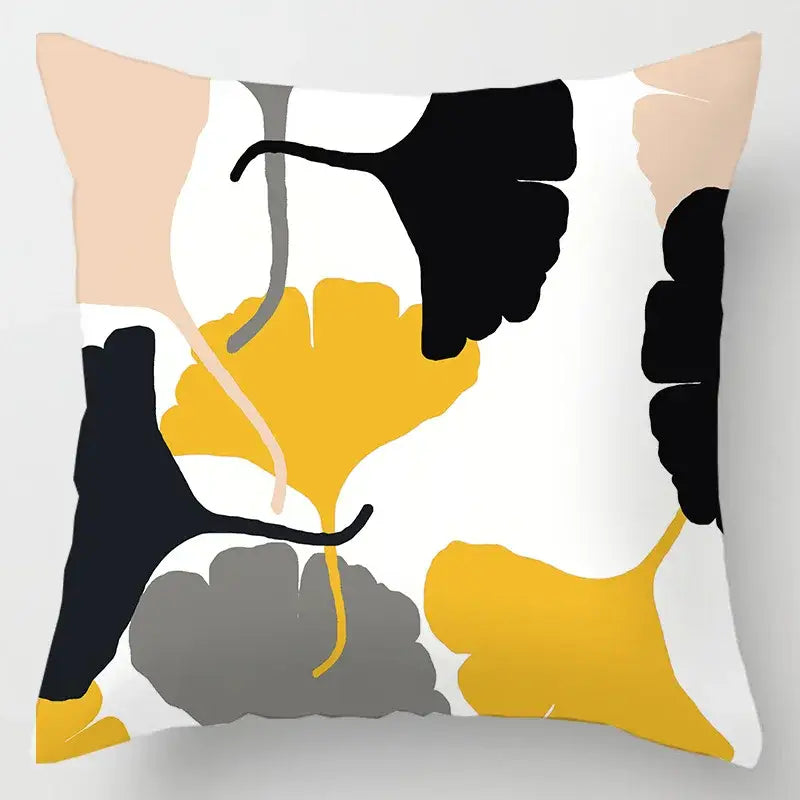 A square cushion cover with modern abstract geometric leaves print in black yellow and gray on white for living room