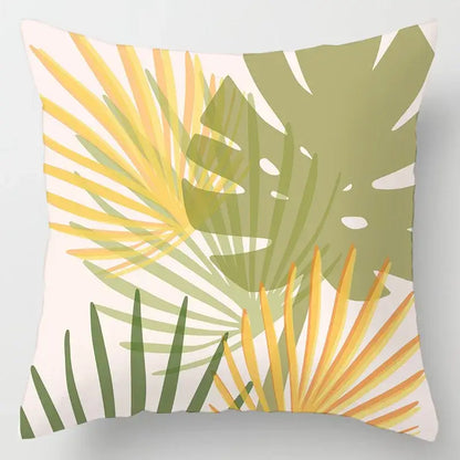 A square throw cushion cover with a vibrant geometric leaves print in yellow green and olive on off-white fabric